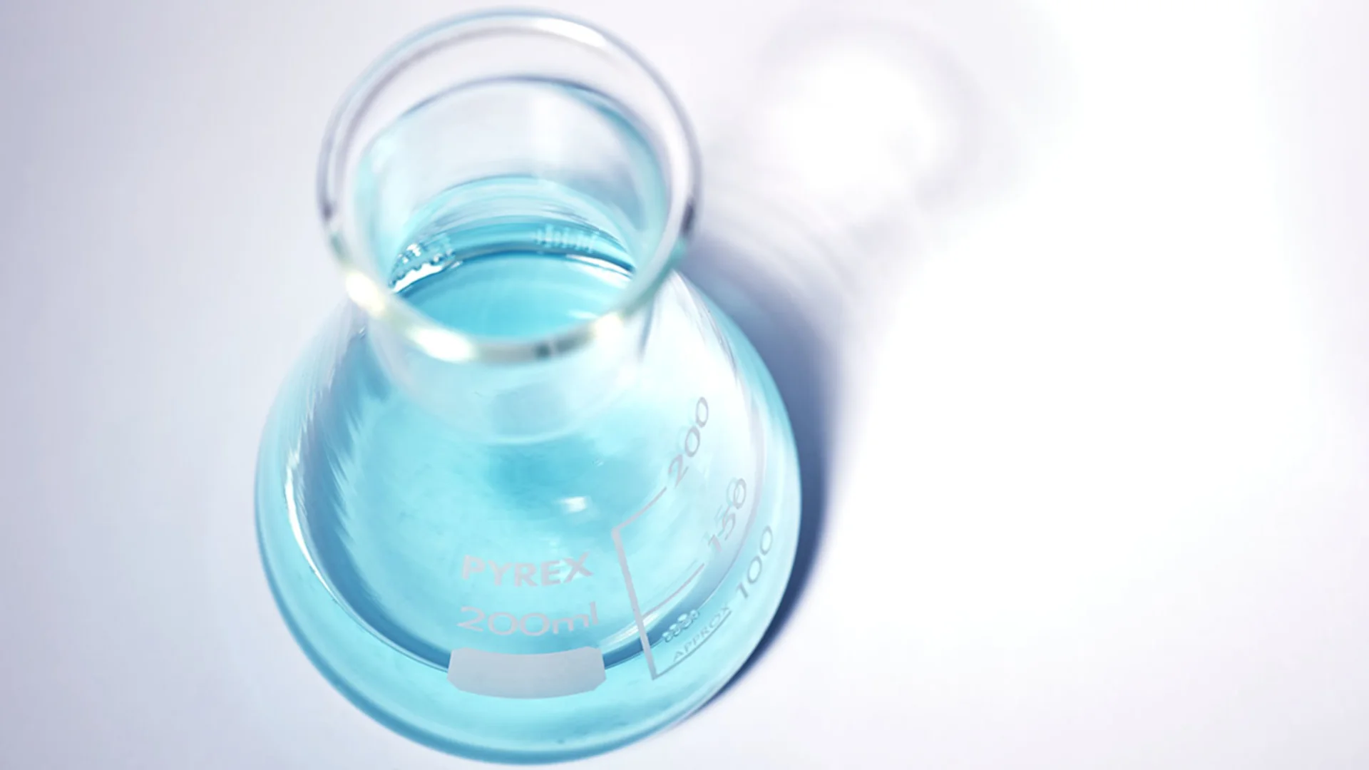 Top down shot of beaker containing AiroPure® Odour Eliminator Solution.